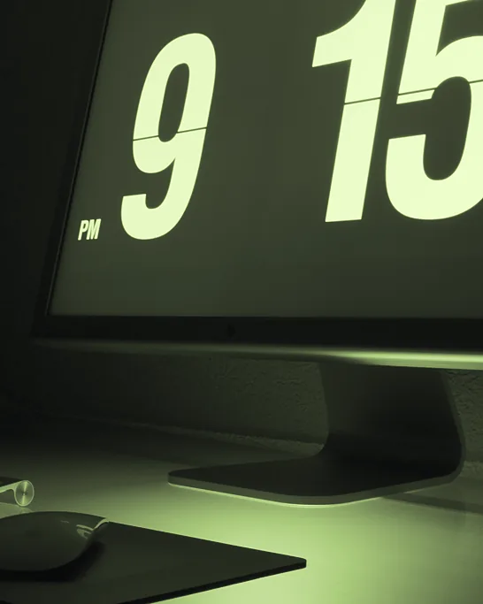 A minimal dark desk: a large display, keyboard and mouse